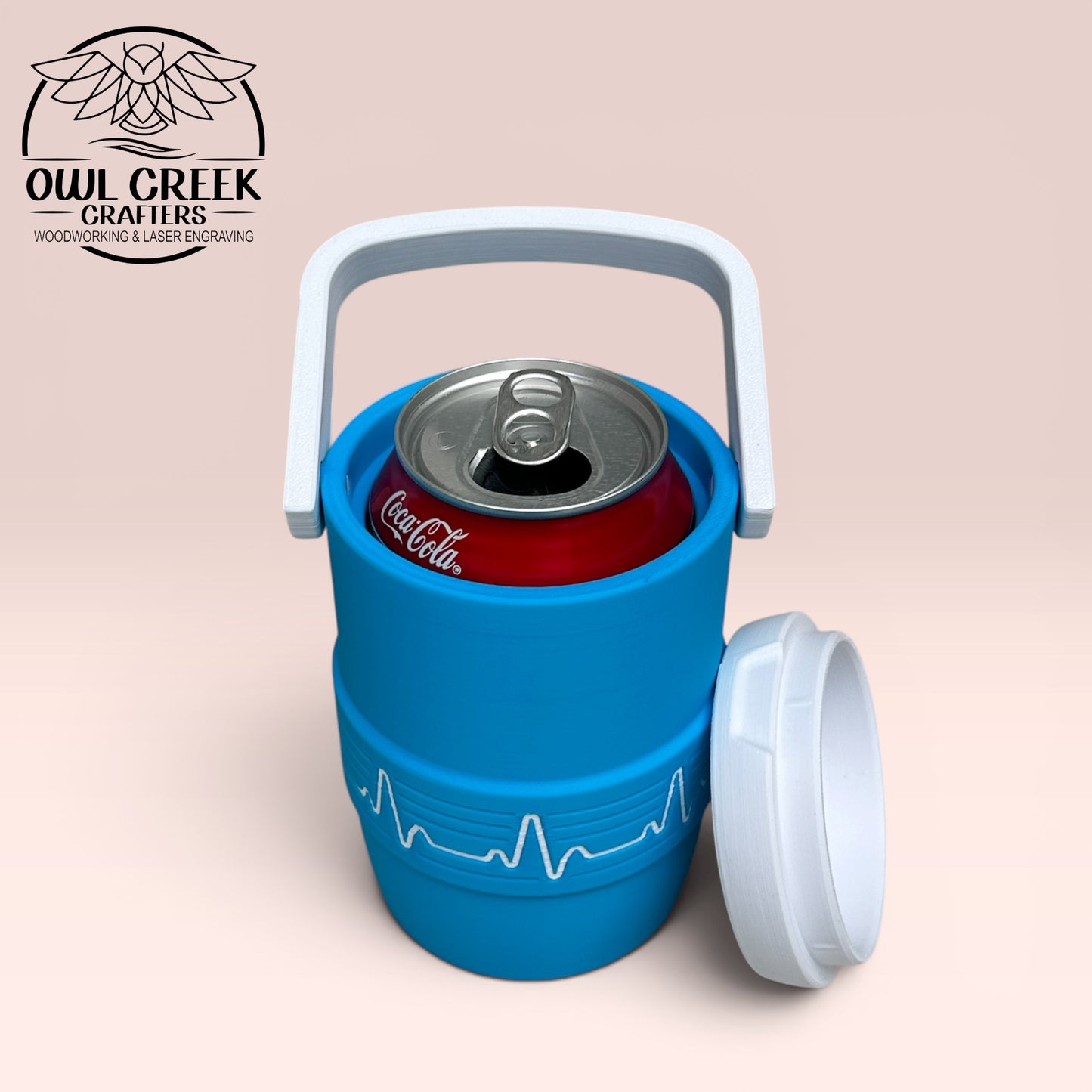 Blue and white can cooler coozie with Coca-Cola can inside, on a beige background with the Owl Creek Crafters Logo