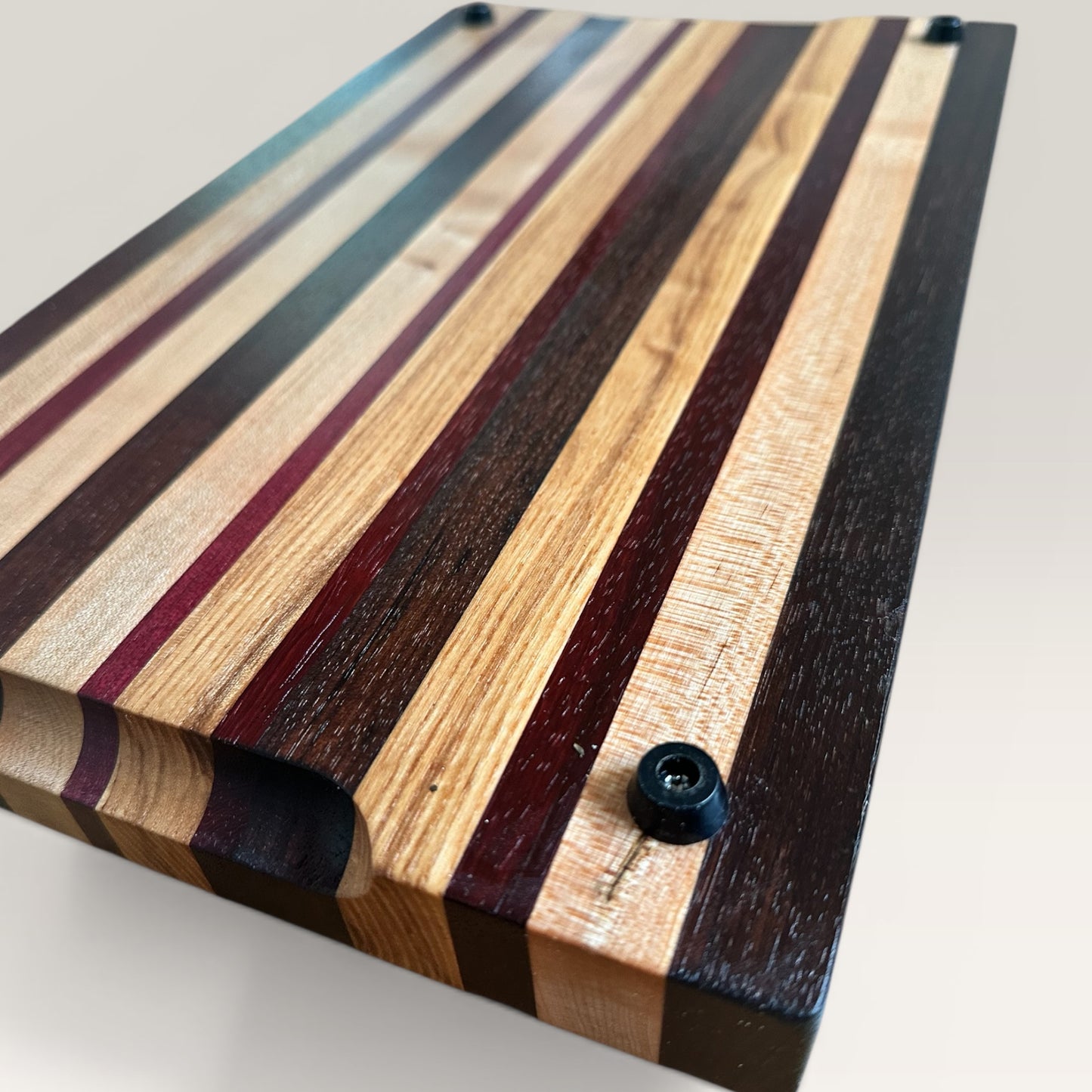Wooden cutting board with striped pattern on a light background