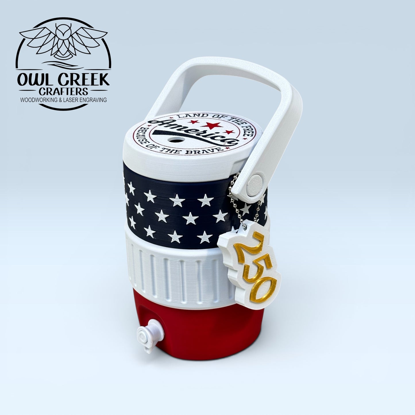 American flag-themed can cooler coozie and a '250' keychain, on a light gray background with the Owl Creek Crafters logo