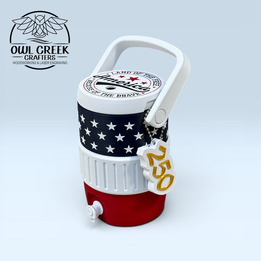 American flag-themed can cooler coozie and a '250' keychain, on a light gray background with the Owl Creek Crafters logo