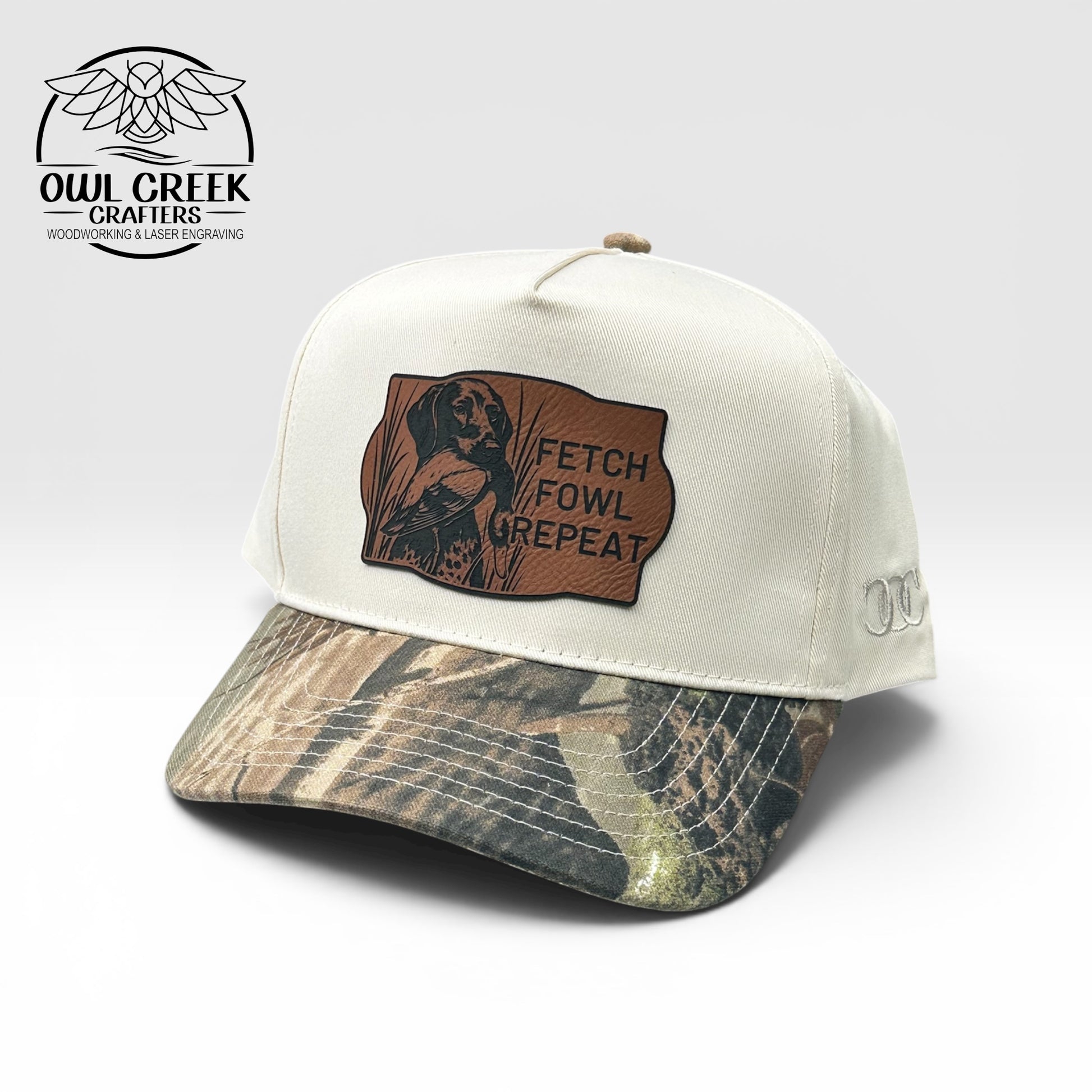 Beige cap with camouflage brim and brown leatherette patch with text on a white background, featuring Owl Creek Crafters logo.