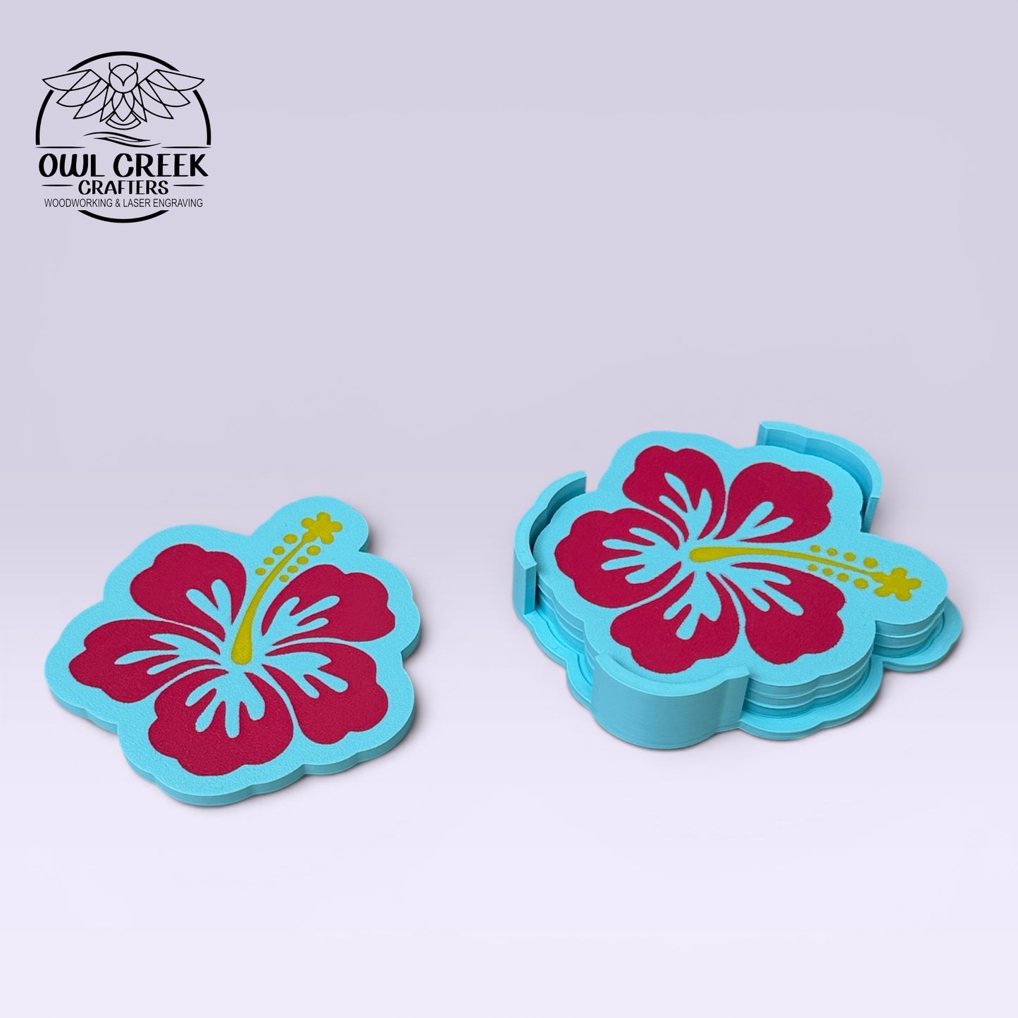 A set of flower-shaped coasters with a turquoise blue base and a red hibiscus flower design with yellow accents, shown on a light gray background. The brand logo 'Owl Creek Crafters' is visible in the top left corner.
