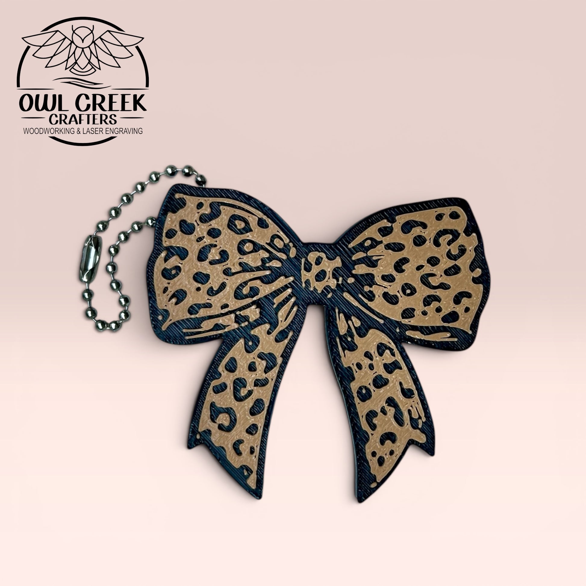 Leopard print bow keychain on a beige background with 'Owl Creek Crafters' logo.