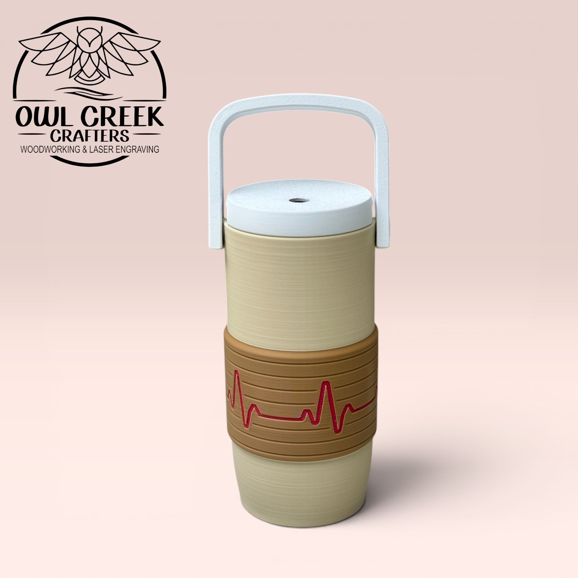 Beige and brown can cooler coozie with a magenta EKG design, and a white handle and lid on a beige background, featuring the Owl Greek Crafters logo.