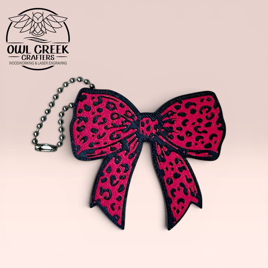 Pink leopard print bow keychain on a beige background with 'Owl Creek Crafters' logo.