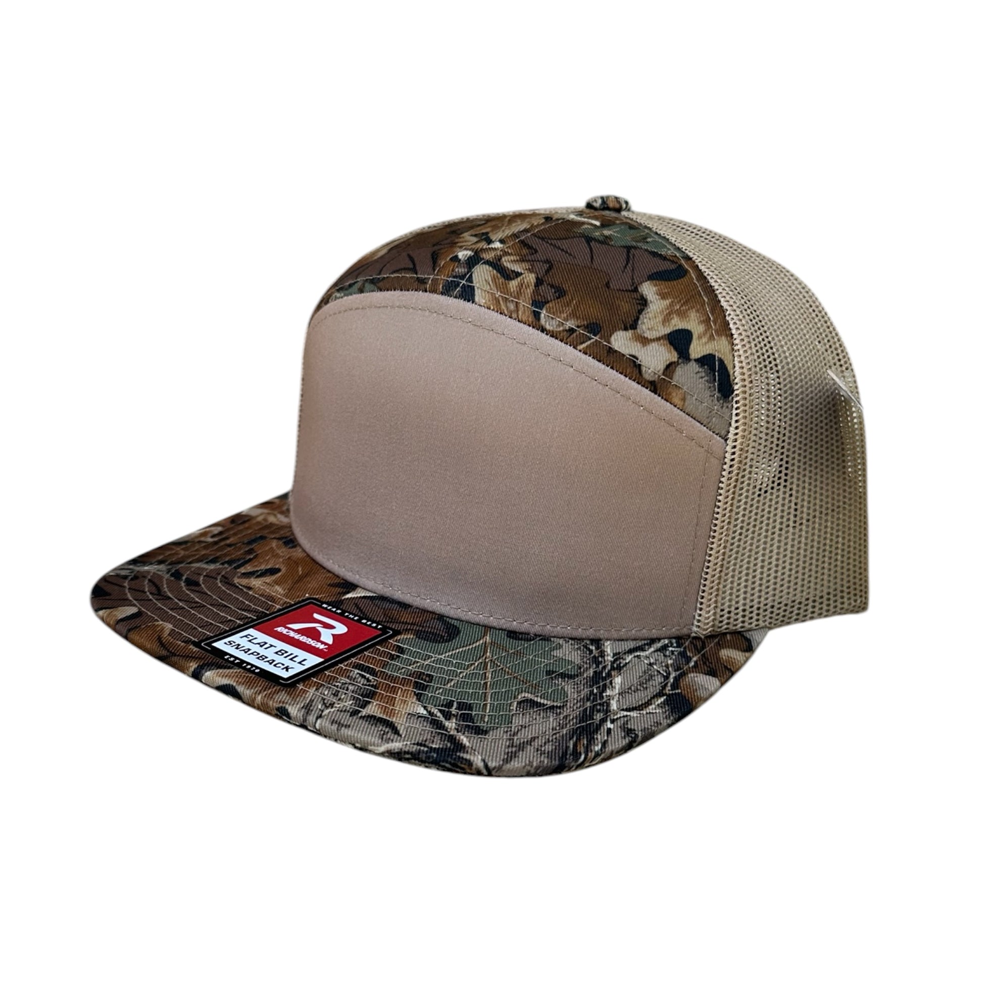 A camouflage trucker hat with a solid tan front panel and mesh back, shown on a plain white background.