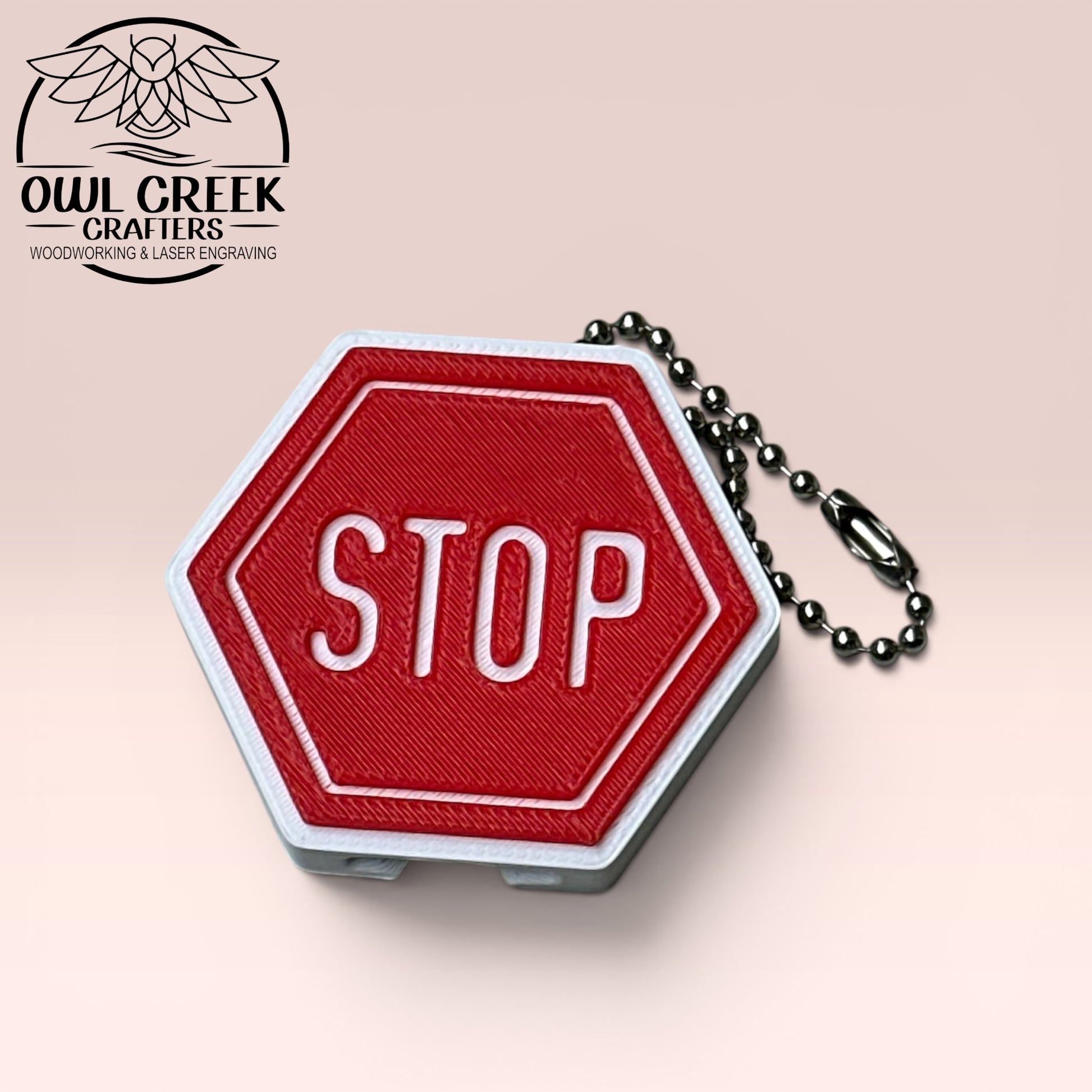 Red 'STOP' sign-shaped keychain with chain on a beige background, featuring Owl Creek Crafters branding.