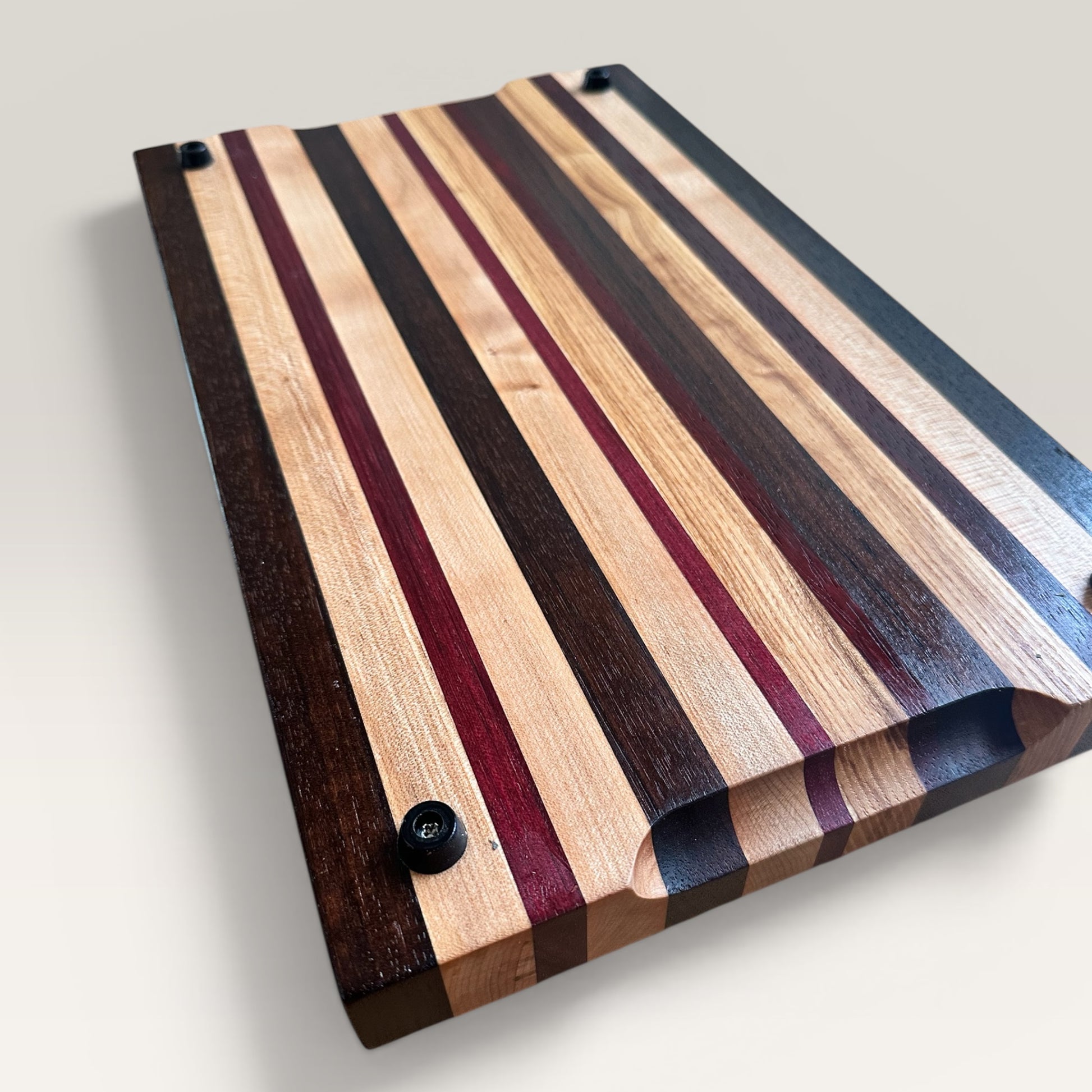 Wooden cutting board with striped pattern on a light gray background