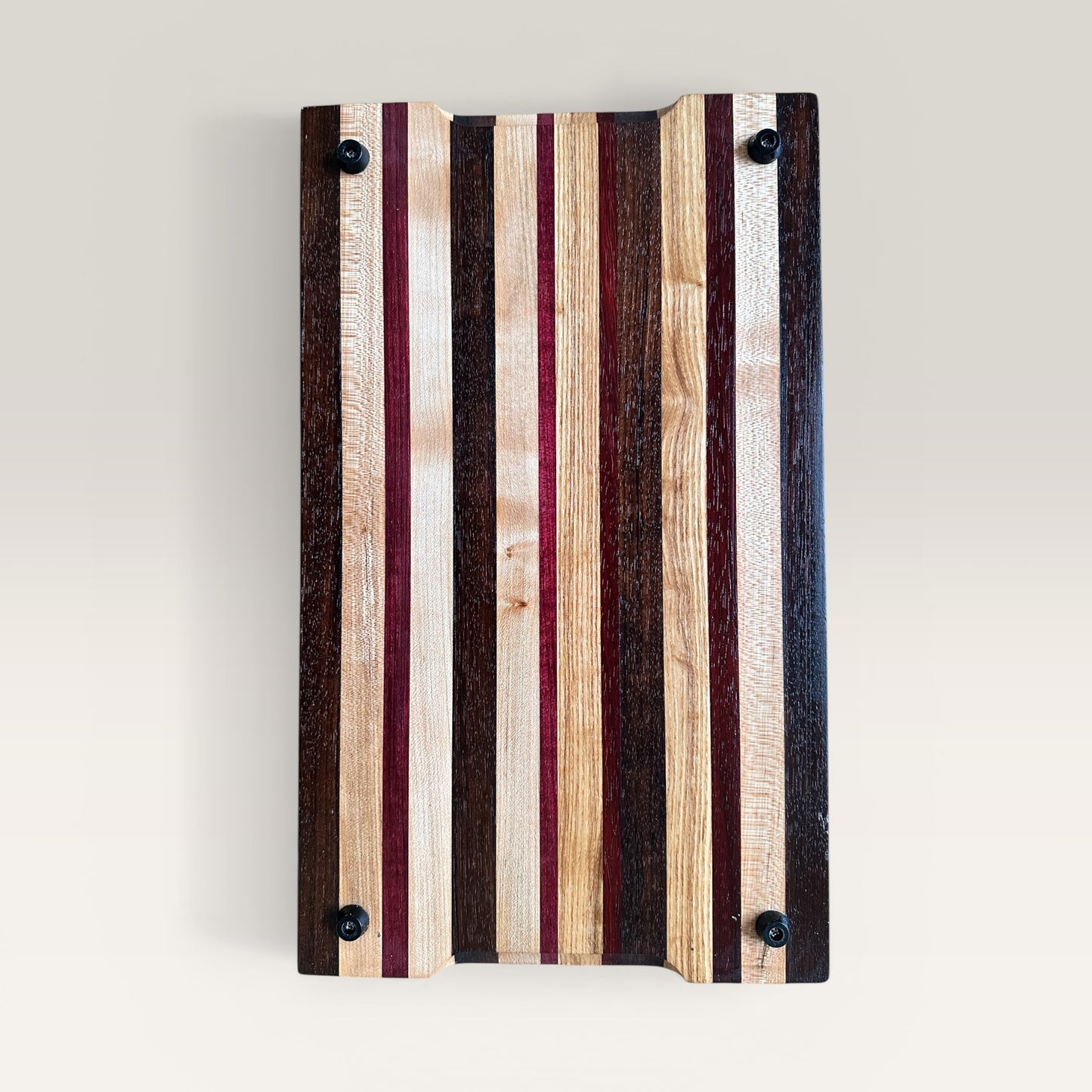 Wooden cutting board with striped pattern on a light gray background