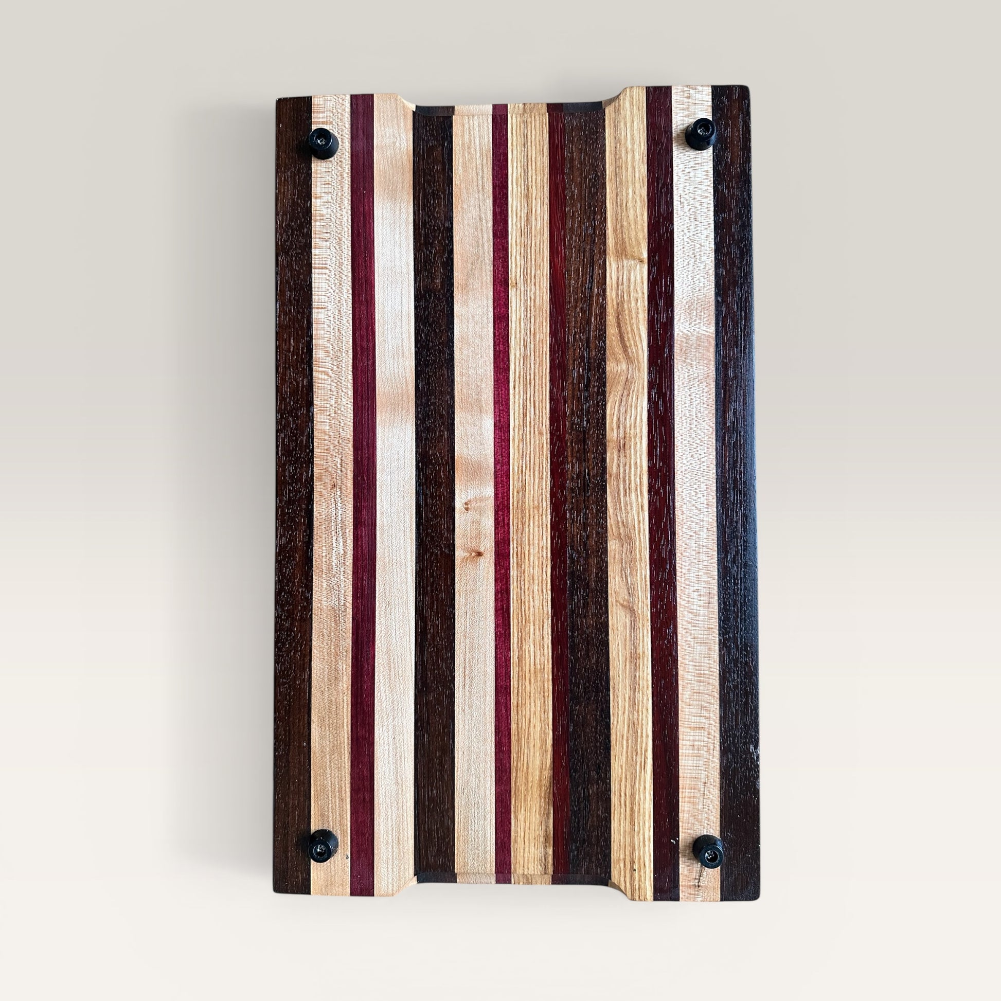 Wooden cutting board with striped pattern on a light gray background