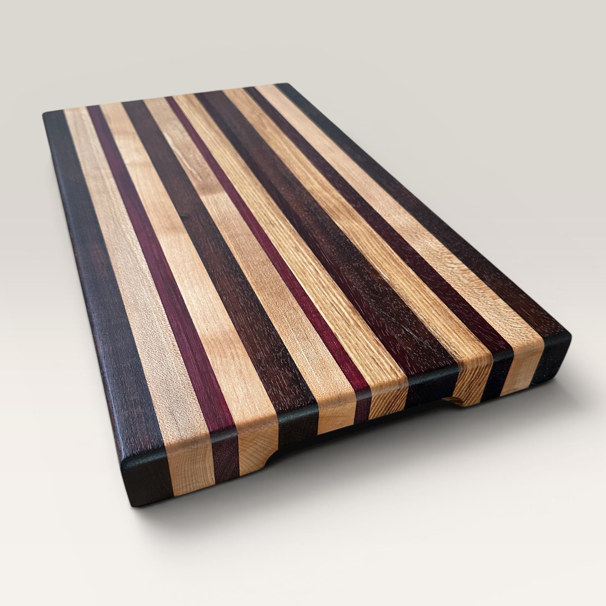 Wooden cutting board with striped pattern on a light gray background