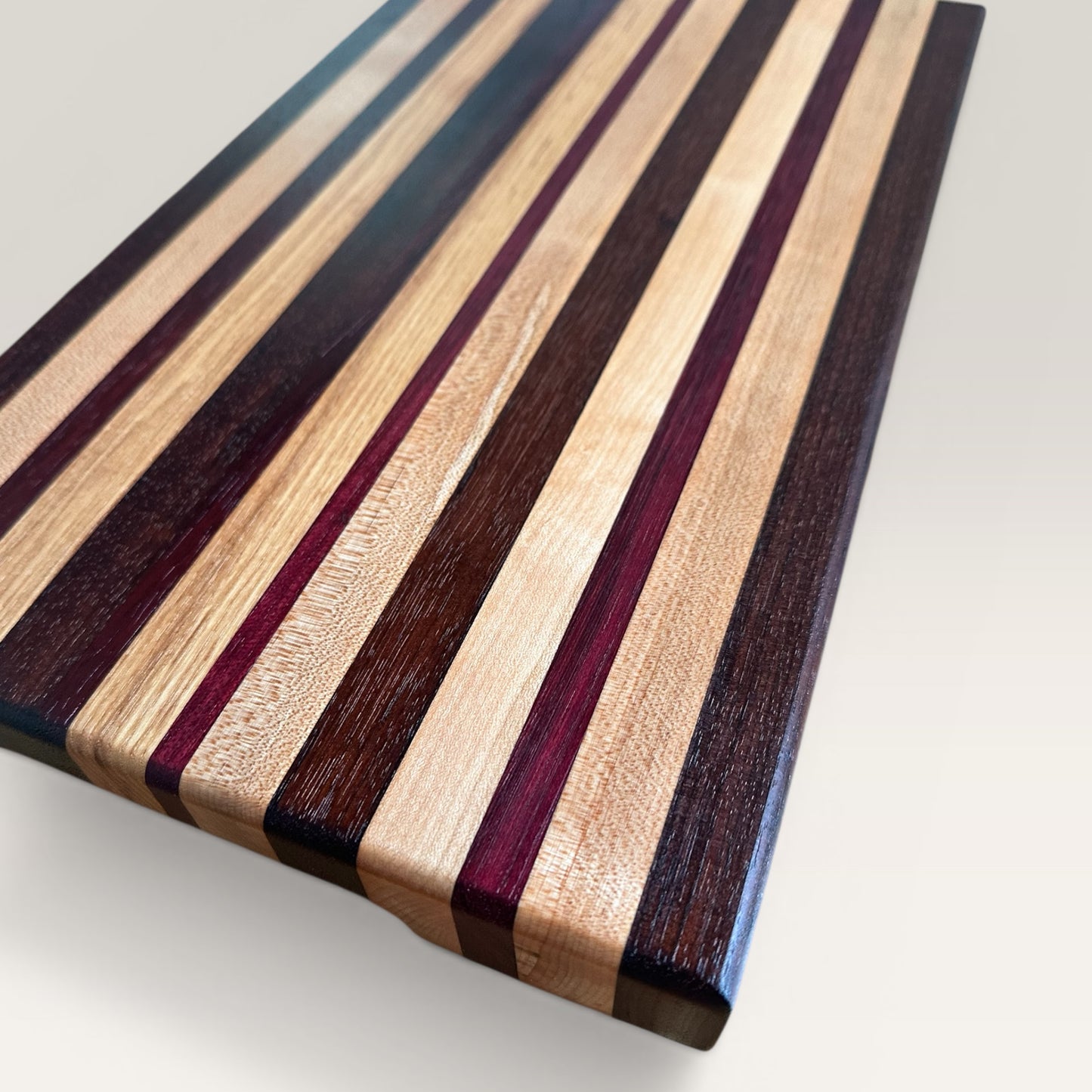 Wooden cutting board with striped pattern on a light background
