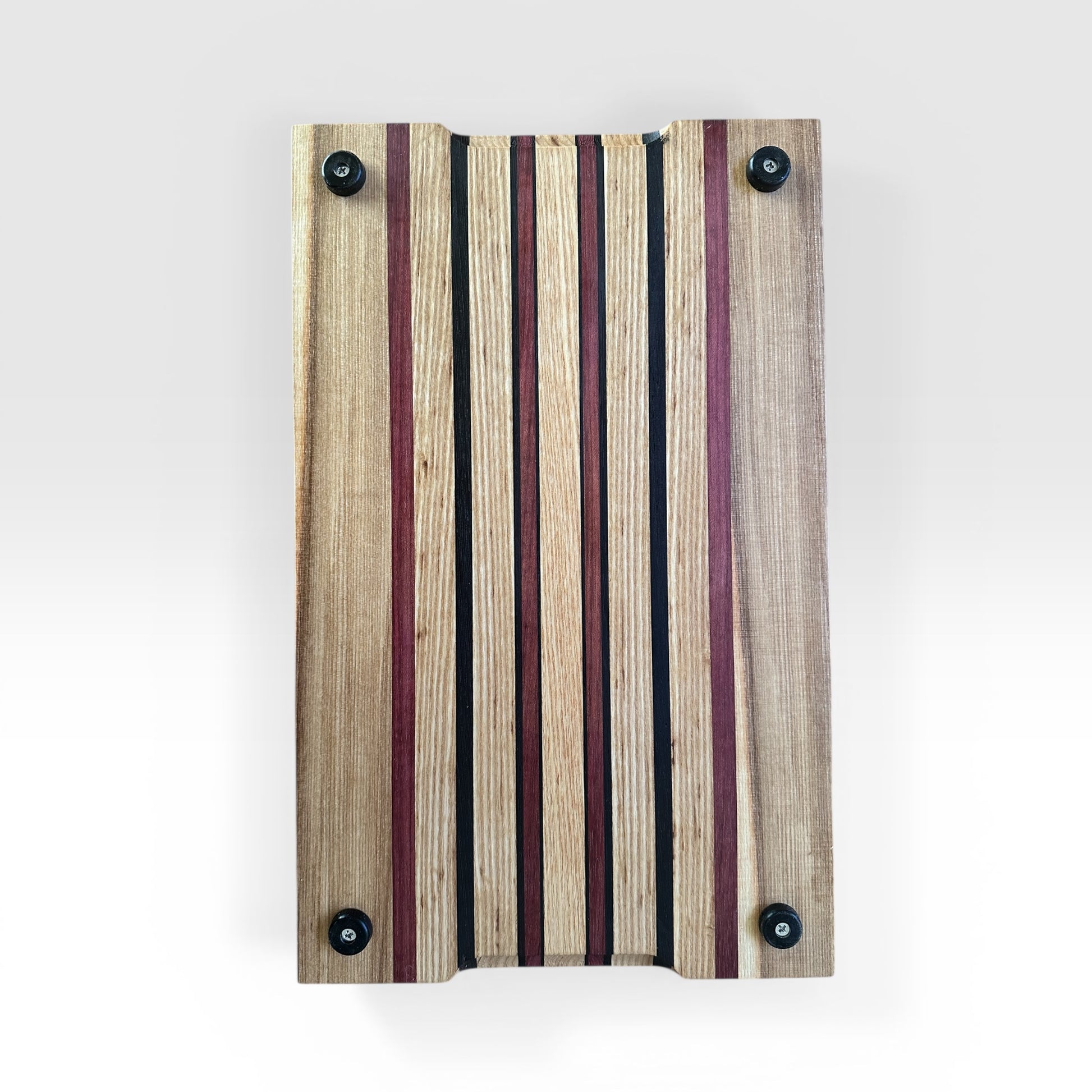 Wooden cutting board with striped pattern on a white background