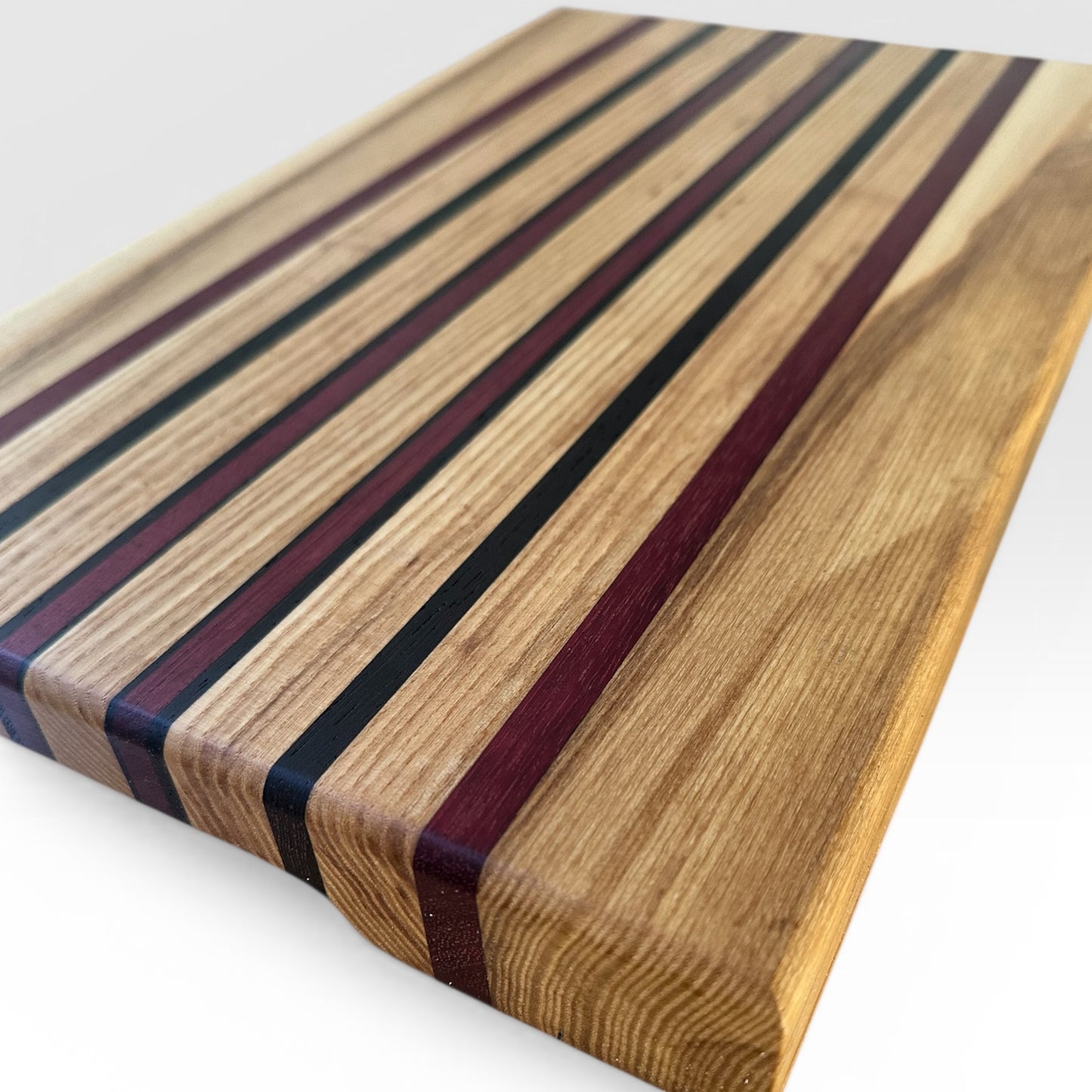 Wooden cutting board with striped pattern on a white background